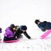 Mike Motowski sleds with his grandchildren Lance, Kate Lund, and Audrey Lund on Friday, Dec. 28. Daniel Brenner I AnnArbor.com